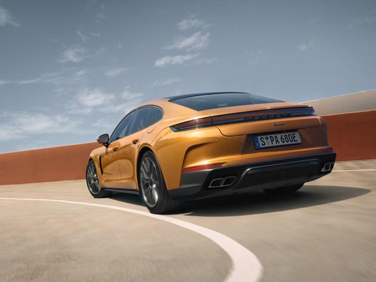 2027 gold porsche panamera turbo driving up a parking garage