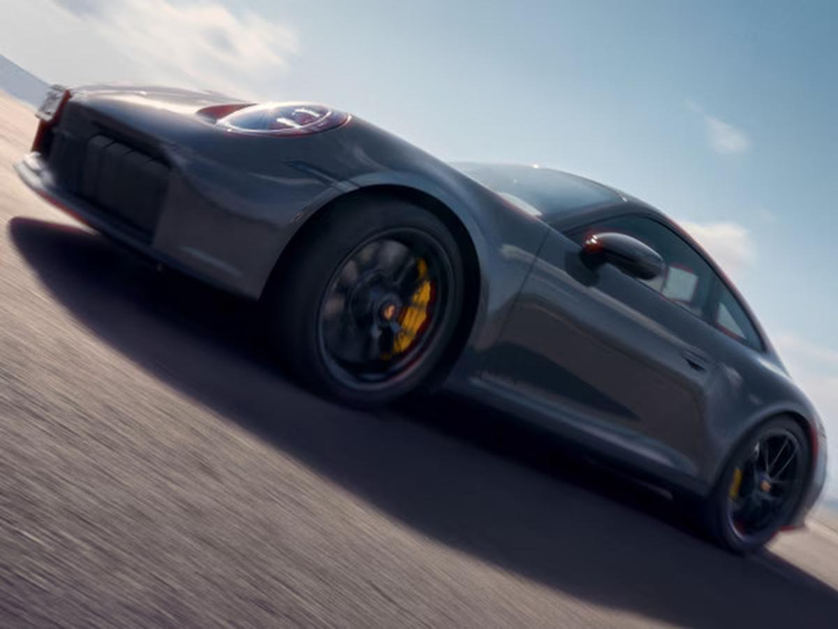 2027 Porsche Carrera driving fast next to the ocean