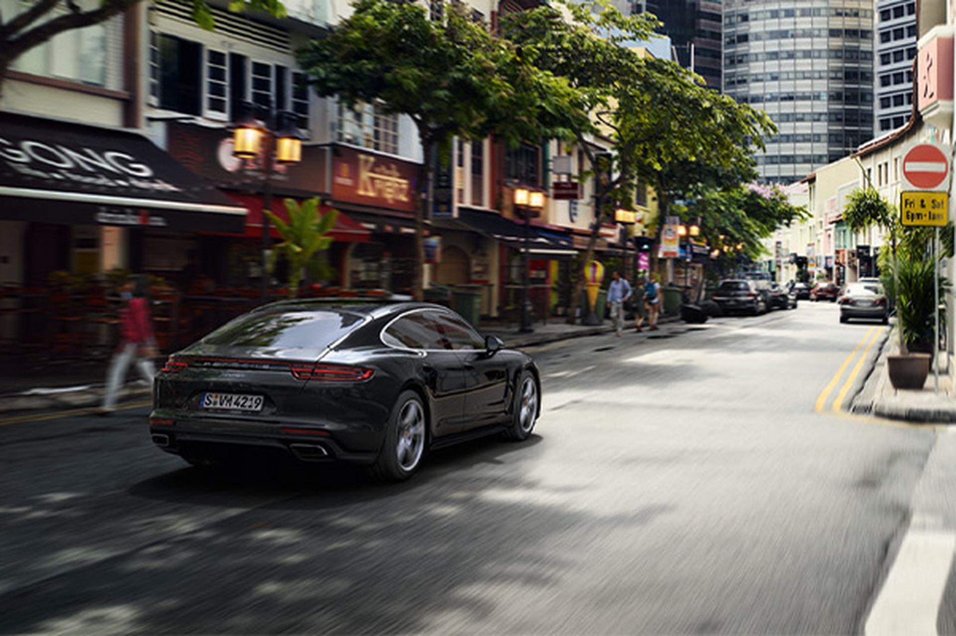 Rear view of a 2020 Porsche Panamara driving down a city street.
