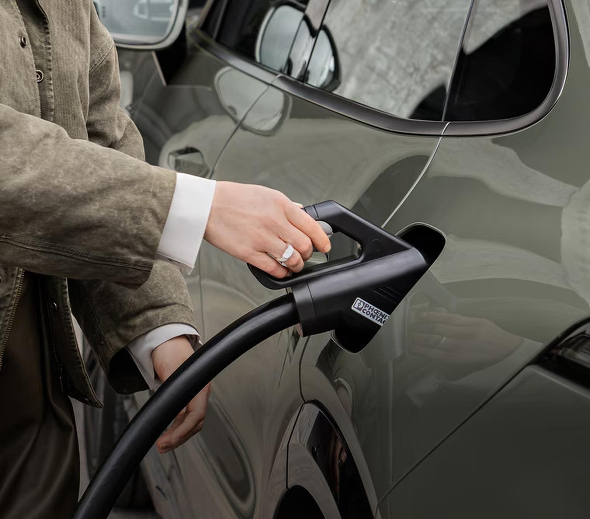 The 2027 Porsche Cayenne Coupe Electric plugged in to a charger