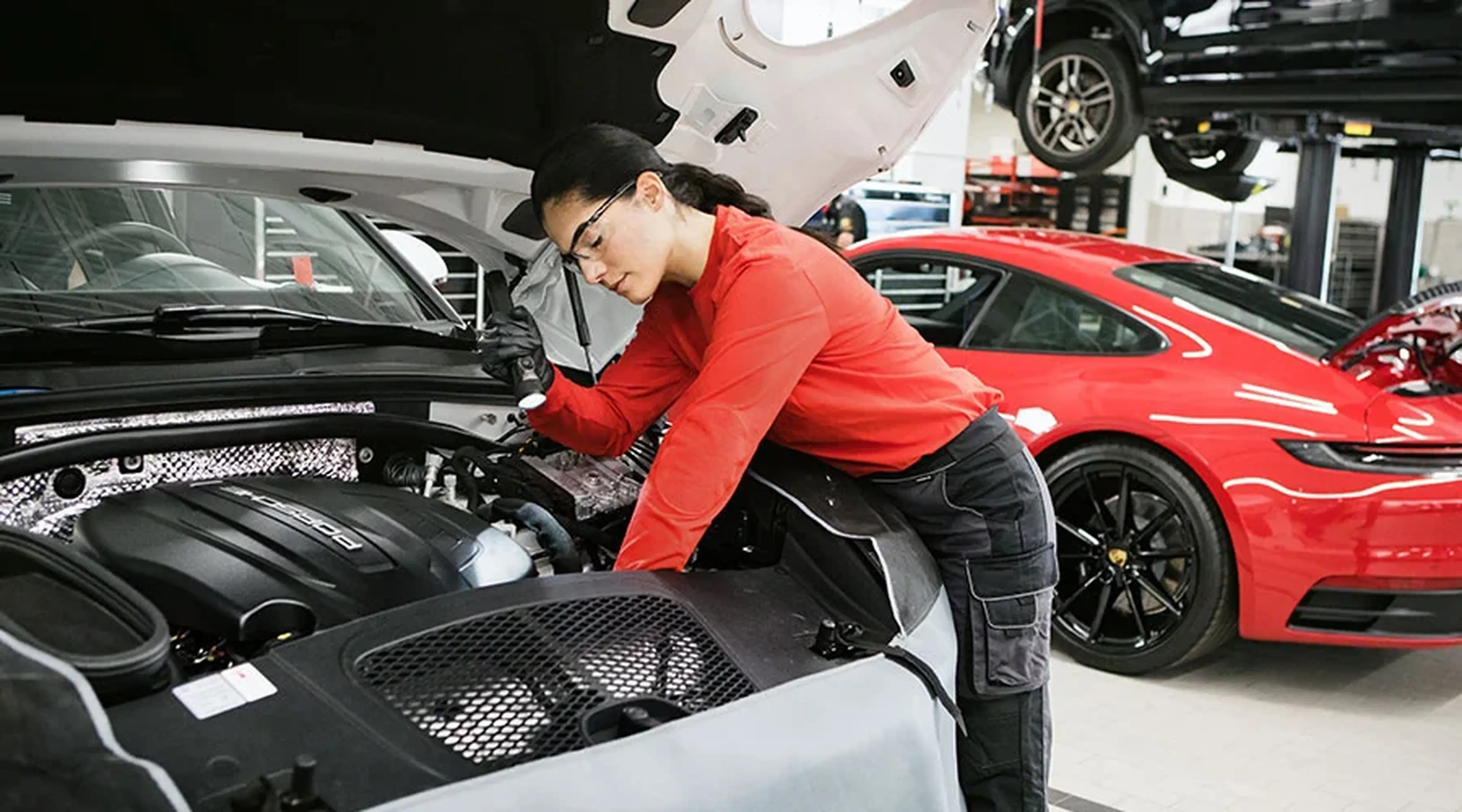 Technician working on a Porsche engine