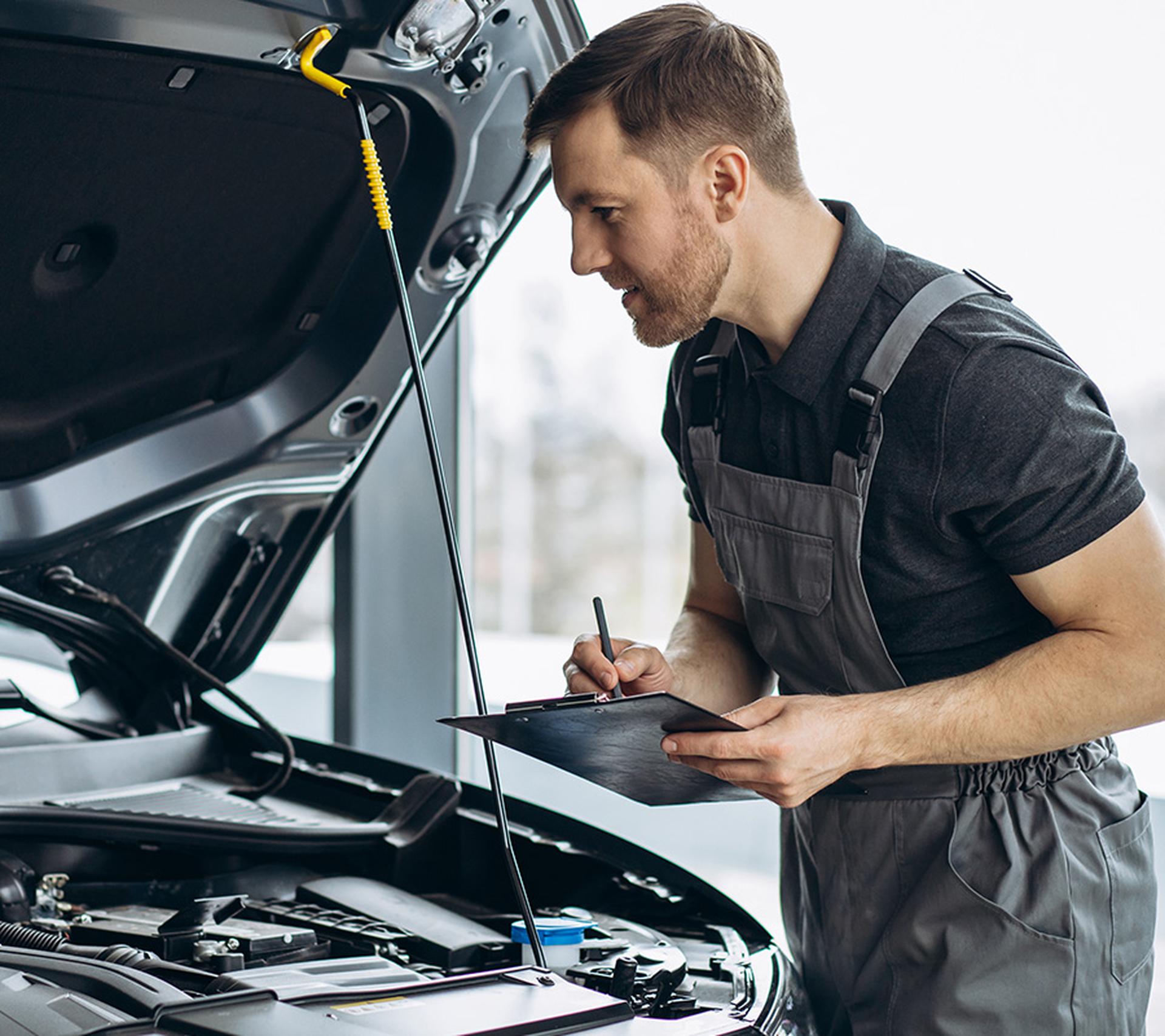 Mechanic inspecting vehicle