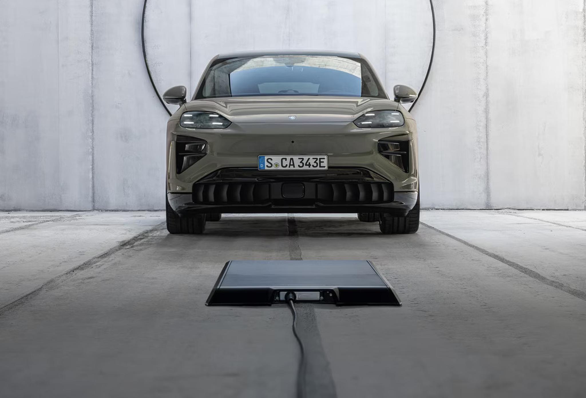 The 2027 Porsche Cayenne Coupe Electric parked in front of charger