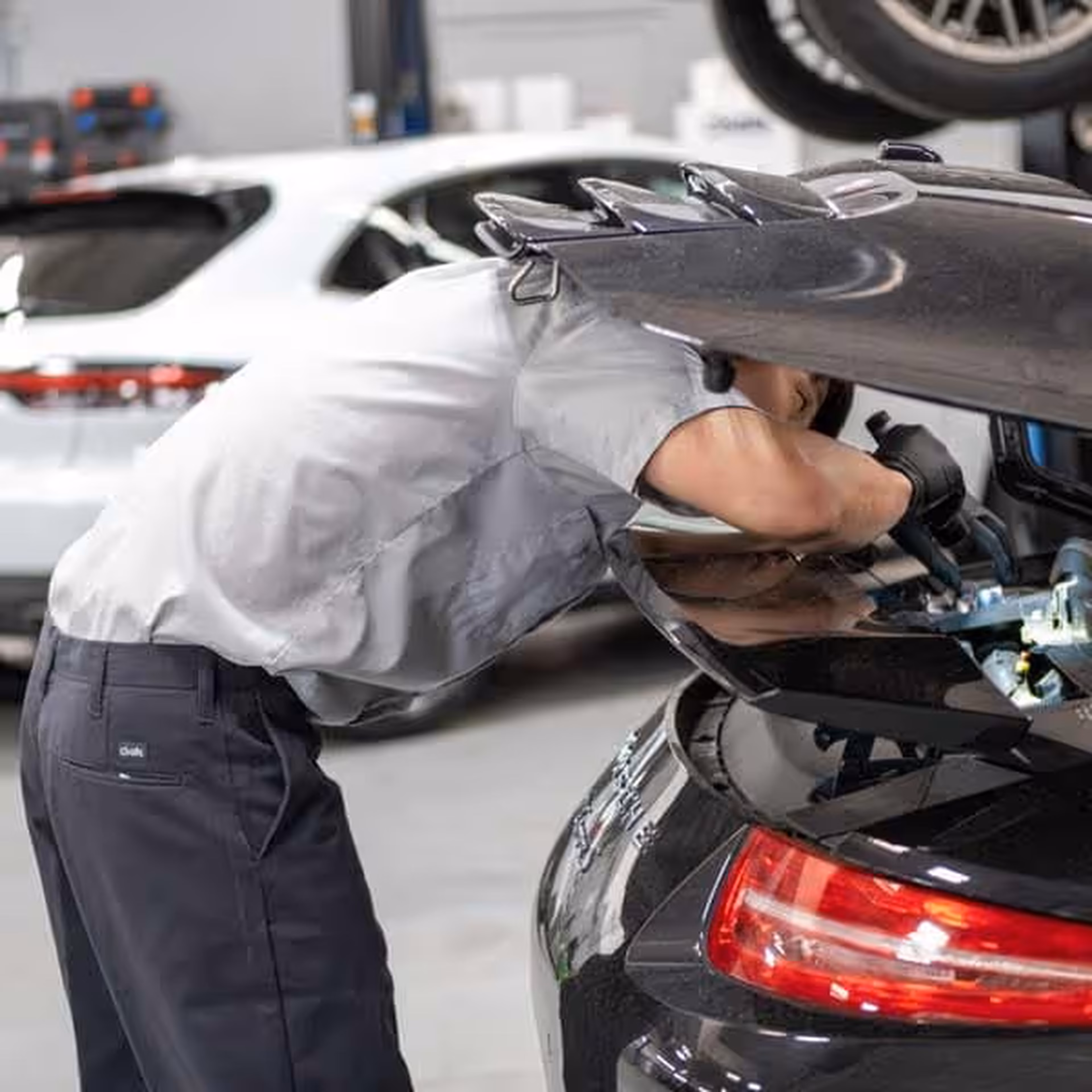 Porsche Technicians Doing an Inspection