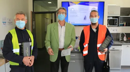 "Scott Bader team in safety vests displaying composite materials and structural adhesives in a laboratory environment" [G]