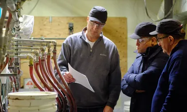 "Technicians examining piping system in Scott Bader manufacturing facility where resins and composites are produced" [G]