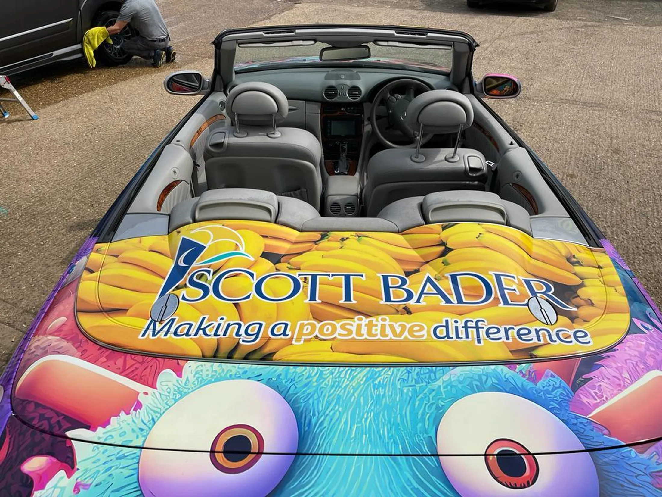 "Convertible car with colorful Scott Bader branded hood wrap showcasing composites and gelcoats applications in automotive design" [G]