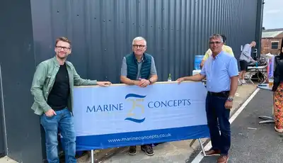 "Team at Marine Concepts event with industrial building backdrop, showcasing marine applications for composites" [G]