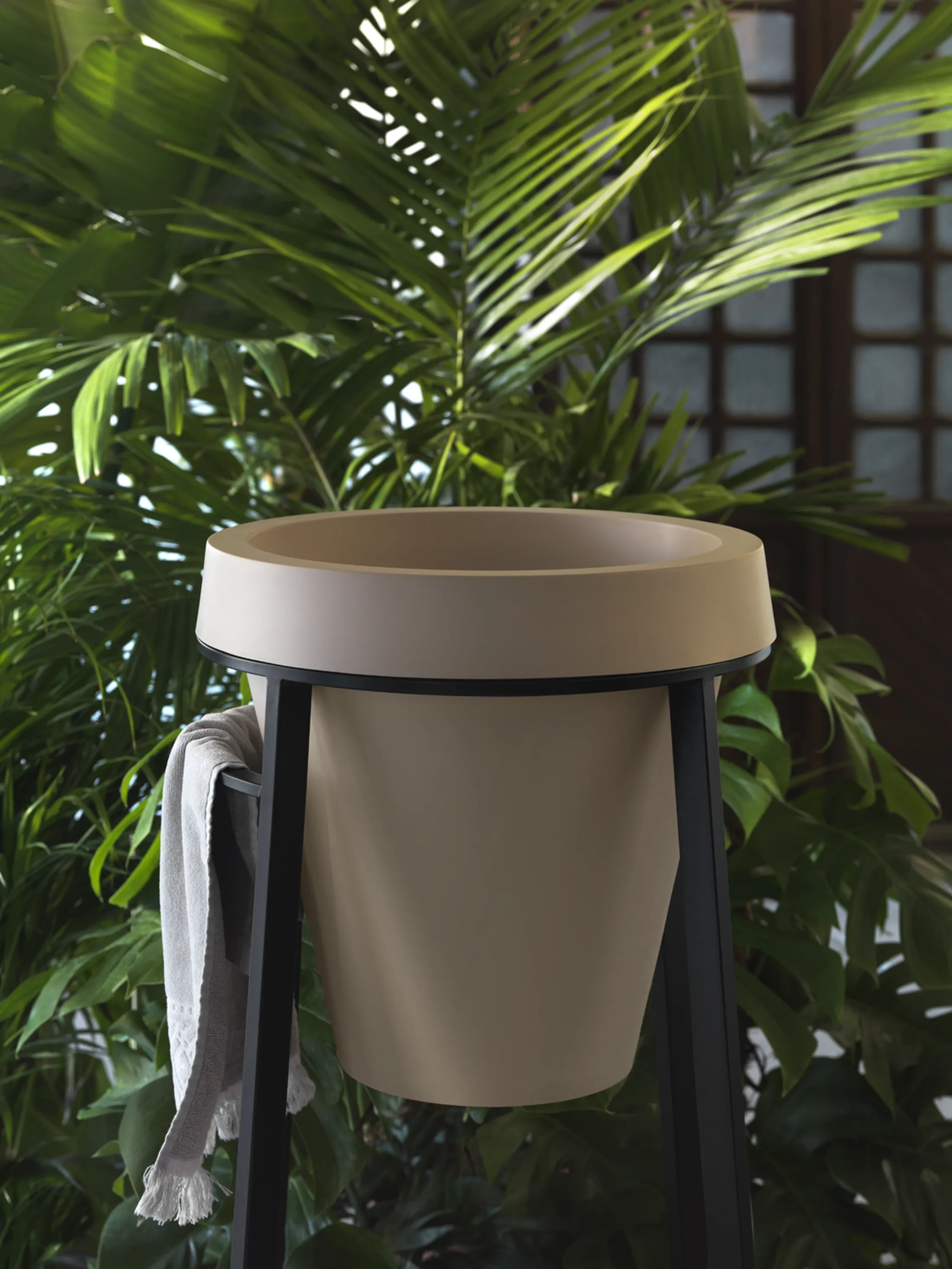 "Modern beige planter with metal stand against lush palm foliage in interior setting" [G]
