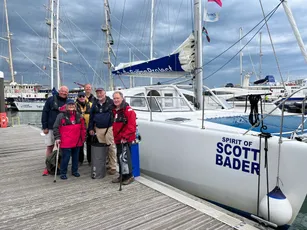 Group with "Spirit of Scott Bader" yacht in marina, showcasing Scott Bader composites and gelcoats in marine applications. [G]