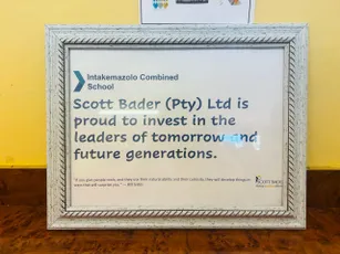 Framed plaque showing Scott Bader's community investment in Intakemazolo Combined School's future leaders. [G]