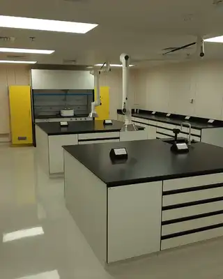 "Modern laboratory workspace with black countertops and white cabinetry, designed for testing Scott Bader resins and composites" [G]