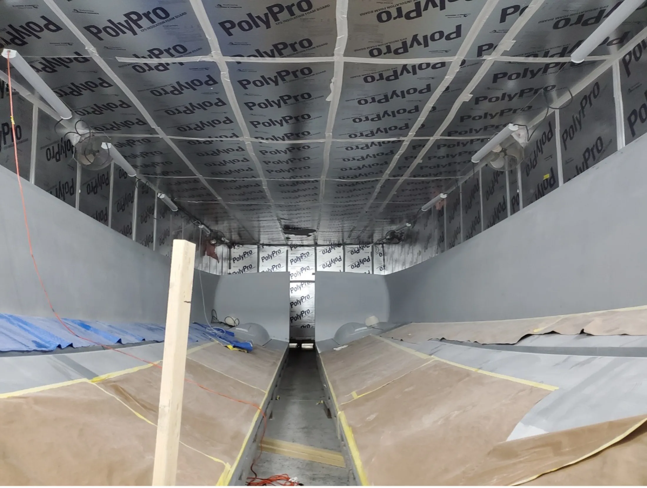 "Interior of boat hull under construction with PolyPro insulation materials, showcasing Scott Bader composites and resins for marine applications" [G]