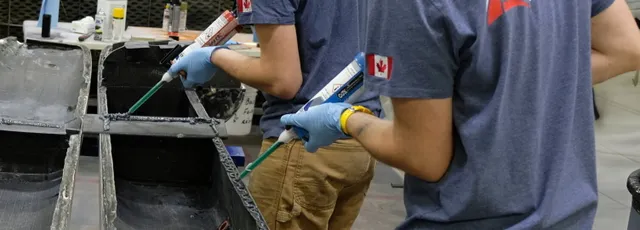 "Technician applying Scott Bader structural adhesives in manufacturing process, showcasing precision bonding for composite assembly" [G]