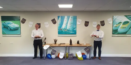 "Scott Bader event showcasing composites and resins with display table and artwork featuring marine, automotive, and transportation applications" [G]
