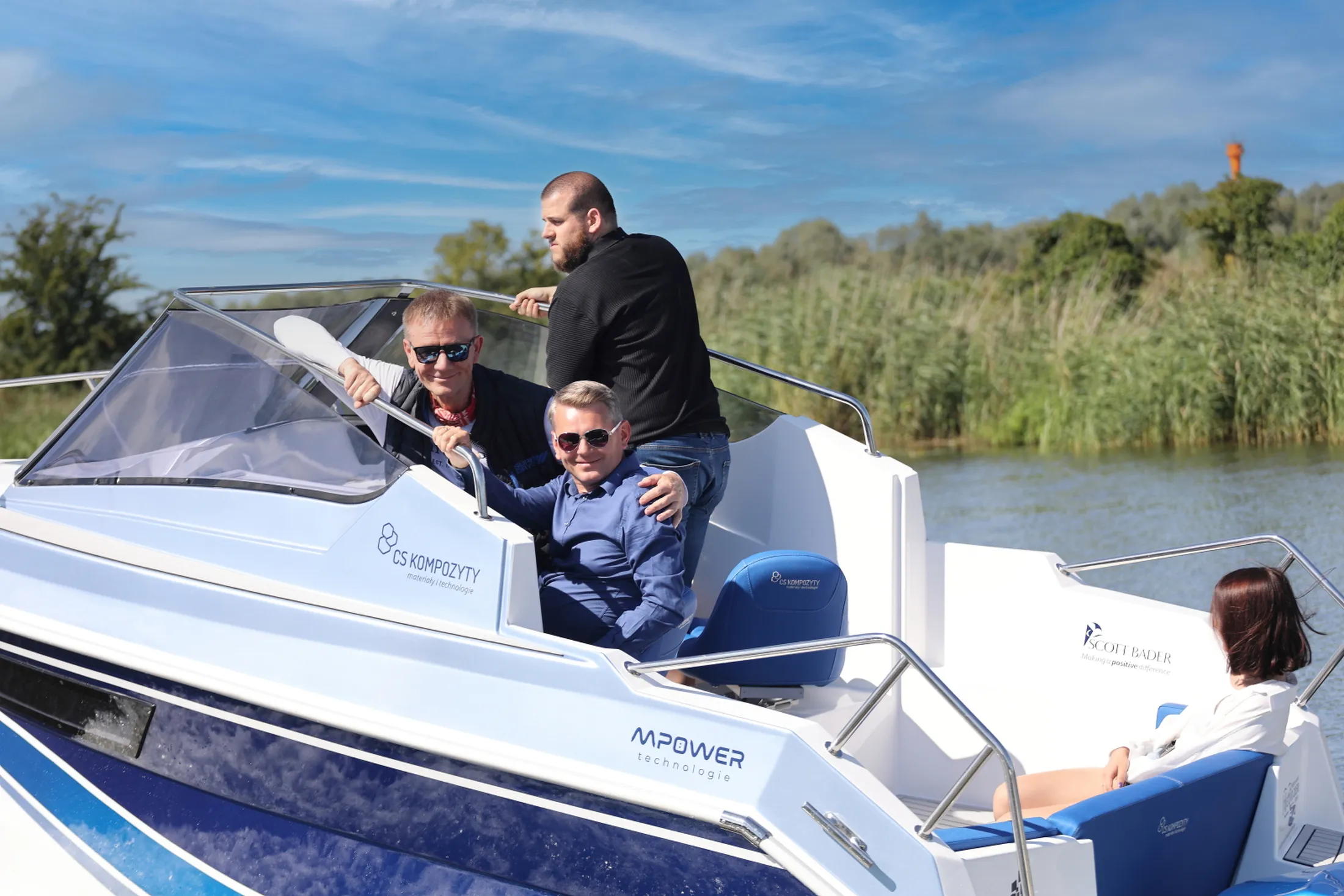 "People enjoying a boat ride on a lake with reeds in background - Scott Bader gelcoats and composites used in marine applications" [G]