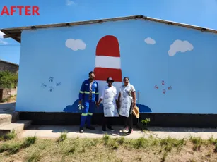 "Renovated building with lighthouse mural painted in Scott Bader composites and resins, featuring three people standing outside" [G]