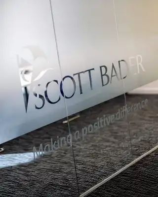 "Scott Bader logo on frosted glass panel with 'Making a positive difference' tagline, showcasing their composites brand identity" [G]