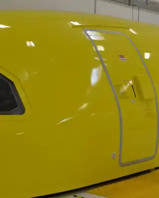"Bright yellow aircraft fuselage with Spirit Airlines branding, showcasing Scott Bader's high-performance gelcoats for aerospace applications" [G]