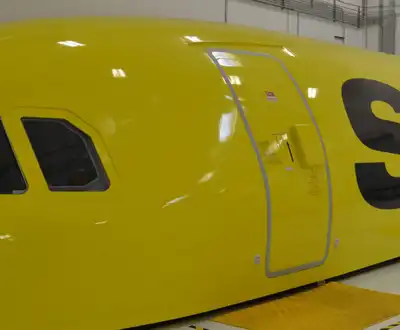 "Bright yellow aircraft fuselage with Spirit Airlines branding, showcasing Scott Bader's high-performance gelcoats for aerospace applications" [G]