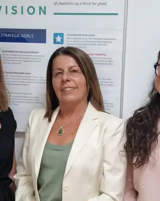 "Professional team in Scott Bader office with European map and vision statement display in background" [G]