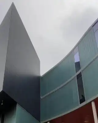 "Modern architectural building with glass panels and angular design, featuring Scott Bader's innovative composites and structural adhesives" [G]