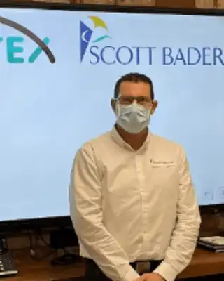 "Presentation screen displaying Pultex and Scott Bader logos with team members in a professional setting" [G]