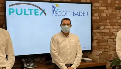 "Presentation screen displaying Pultex and Scott Bader logos with team members in a professional setting" [G]