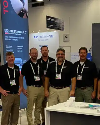 "Scott Bader team at industry exhibition showcasing composites and adhesives solutions at their professional trade show booth" [G]