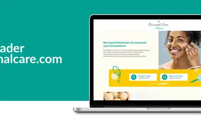 "Laptop displaying Scott Bader's personalcare.com website featuring skincare product information on teal background" [G]