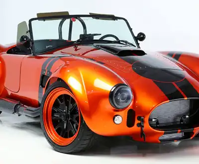 "Sleek orange sports car showcasing Scott Bader composites and gelcoats for high-performance automotive applications" [G]