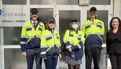 "Scott Bader office entrance with team members in high-visibility safety workwear, showcasing the company's composites facility" [G]