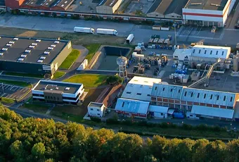 "Aerial view of Scott Bader manufacturing facility with industrial buildings where composites, resins and adhesives are produced" [G]