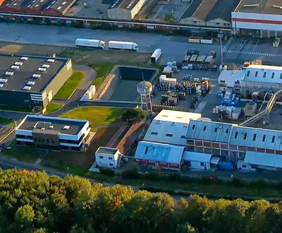 "Aerial view of Scott Bader manufacturing facility with industrial buildings where composites, resins and adhesives are produced" [G]