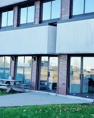 "Modern commercial building with large windows, likely a Scott Bader facility for composites and adhesives manufacturing" [G]