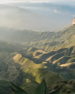 "Panoramic mountain landscape with sunlight streaming across rugged terrain, featuring Scott Bader logo - Making a positive difference" [G]