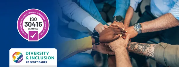 "Scott Bader team members joining hands, showcasing diversity and inclusion values alongside ISO 30415 certification" [G]
