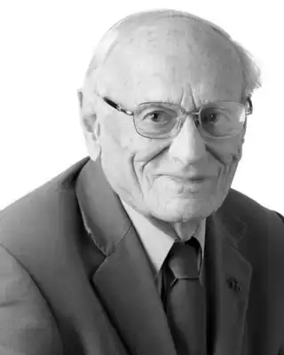 "Professional portrait of an elderly gentleman in a suit and tie, associated with Scott Bader's leadership in composites and adhesives" [G]