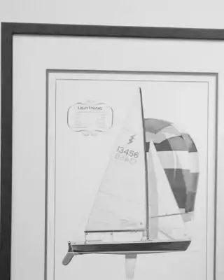 "Memorial portrait with framed sailboat sketch at Scott Bader, honoring contributions to marine composites industry (1933-2021)" [G]