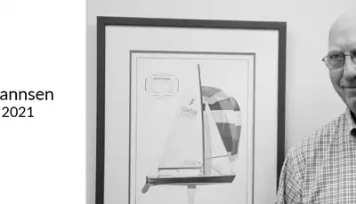 "Memorial portrait with framed sailboat sketch at Scott Bader, honoring contributions to marine composites industry (1933-2021)" [G]
