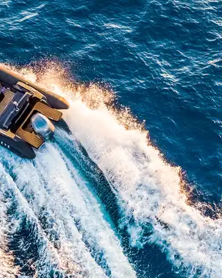 "Aerial view of speedboat cutting through blue water, showcasing Scott Bader gelcoats and composites used in marine applications" [G]