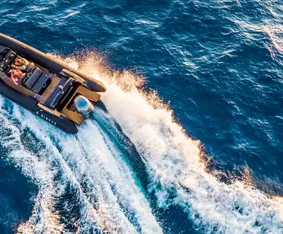 "Aerial view of speedboat cutting through blue water, showcasing Scott Bader gelcoats and composites used in marine applications" [G]