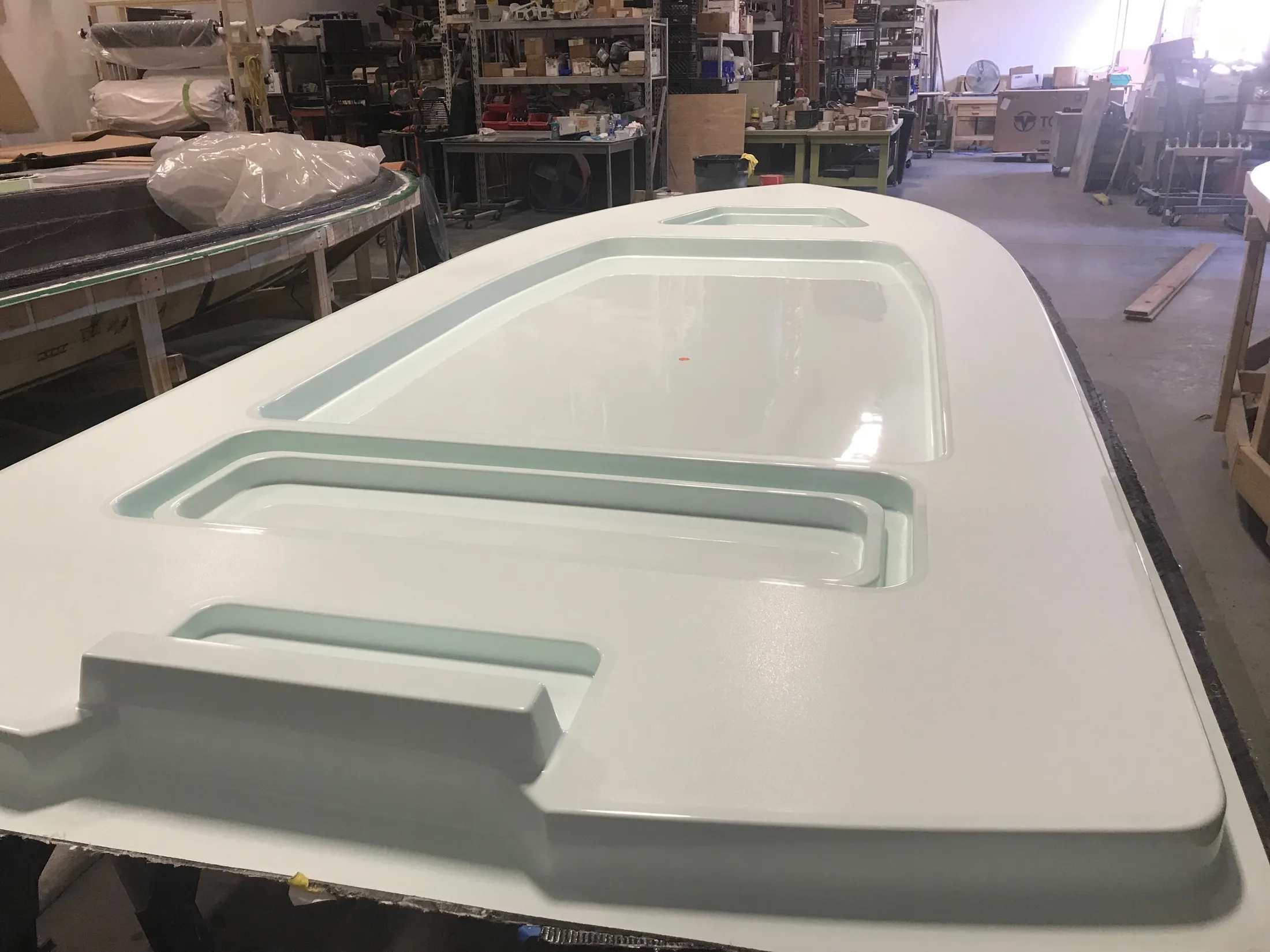 "Boat hull mold in manufacturing facility showcasing Scott Bader gelcoats for marine composites production" [G]
