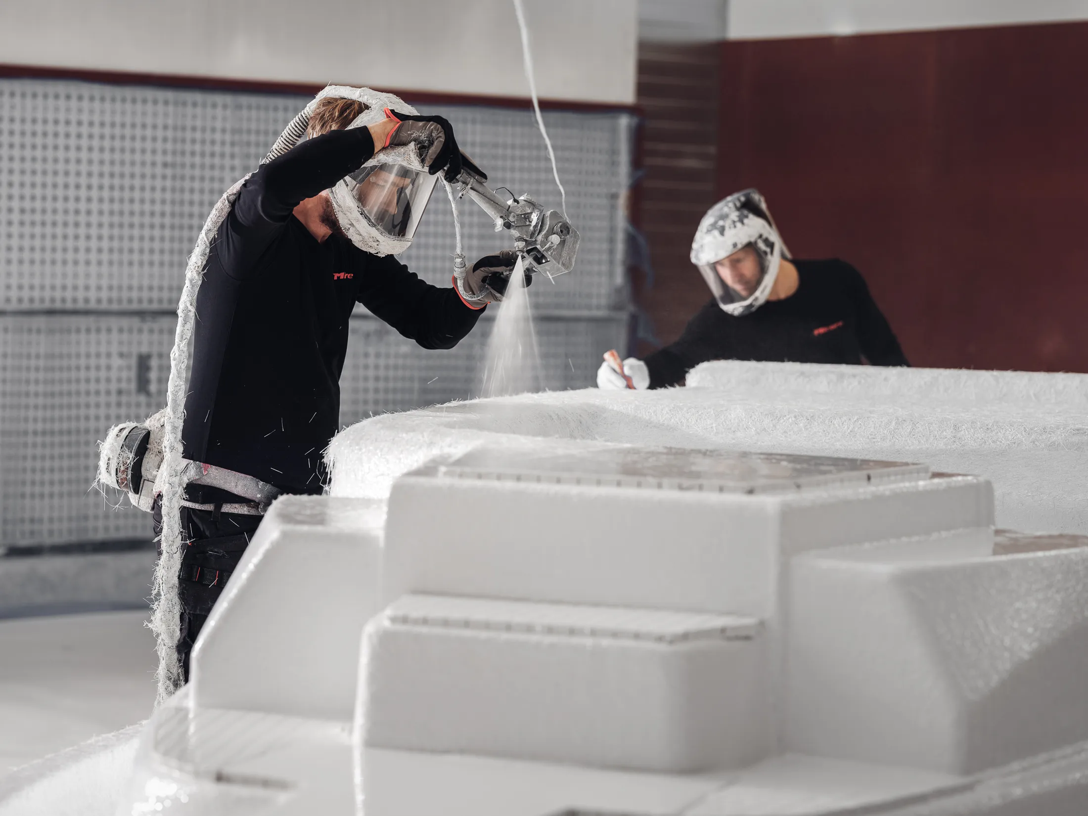 "Technicians applying Scott Bader gelcoats to a boat mold in manufacturing facility, showcasing composites application process" [G]
