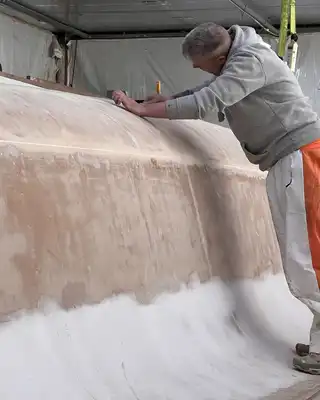 Worker sanding a boat hull mould, Scott Bader composites and resins for marine manufacturing [G]