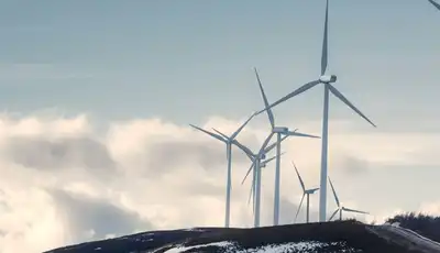 "Wind turbines on snowy hillside - Scott Bader composites and structural adhesives for renewable energy applications" [G]