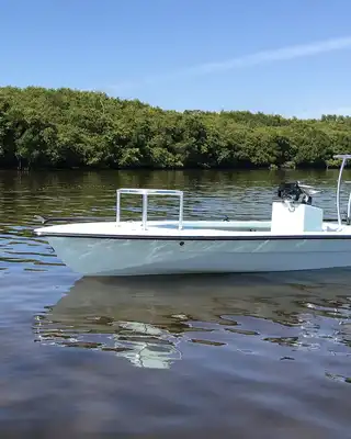 "White motorboat on calm water with mangrove shoreline - Scott Bader composites and gelcoats for marine applications" [G]