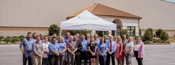 "Scott Bader team gathered outside manufacturing facility, showcasing company's expertise in composites, resins and adhesives" [G]
