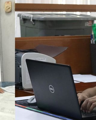 "Two professionals working in a Scott Bader office environment - one examining documents while another uses a laptop" [G]