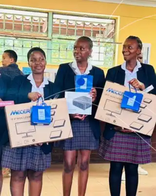 Students in school uniforms holding donated boxes, community outreach supported by Scott Bader. [G]